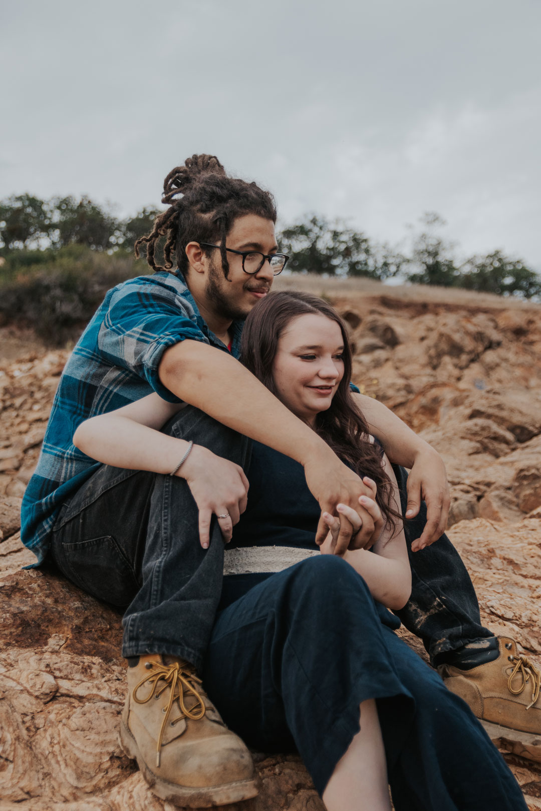 Couple Embraced on Rock Formation